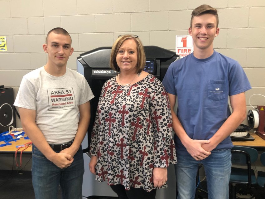 Neshoba Central High School engineering teacher Sedera Anderson, center, was named Mississippi Technology Student Association Teacher of the Year after her students captured several awards at the state competition. At left is Damien Clark, president of the Neshoba Central TSA Chapter, and at right is Kaden McDonald.